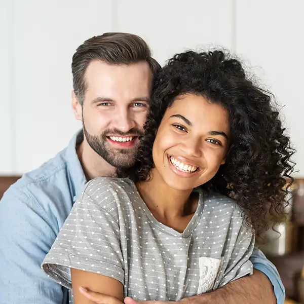 Smiling couple hugging